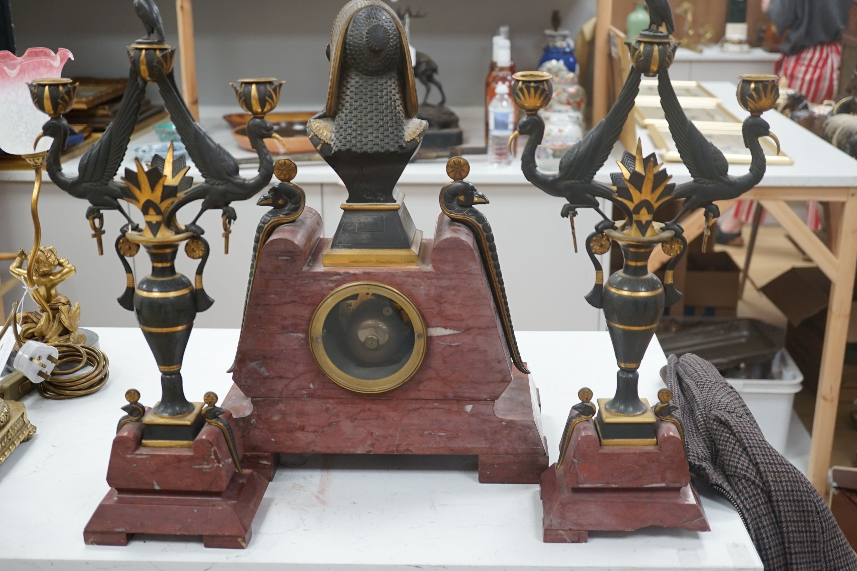 A late 19th century French Egyptian Revival gilt bronze and rouge marble clock garniture, 51cm